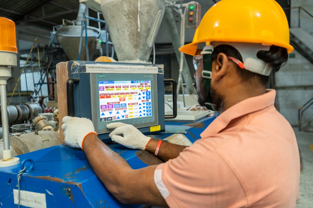 Technician operating a Siemens production control interface